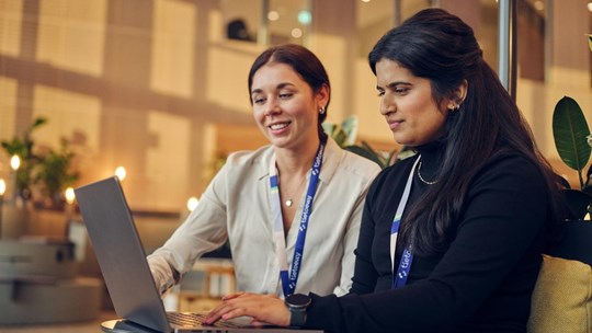 Two employees (women) working with laptop together