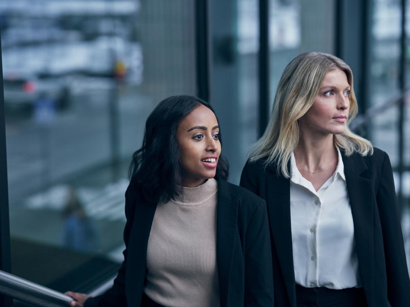 Two business women looking away