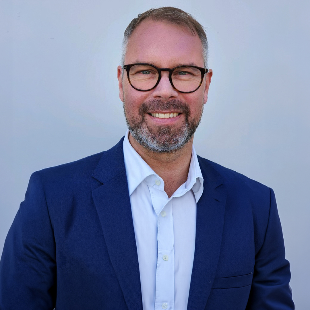 Gunnar Koren leads fraud prevention at Tieto Banktech. He is dressed in a blue suit in the picture.